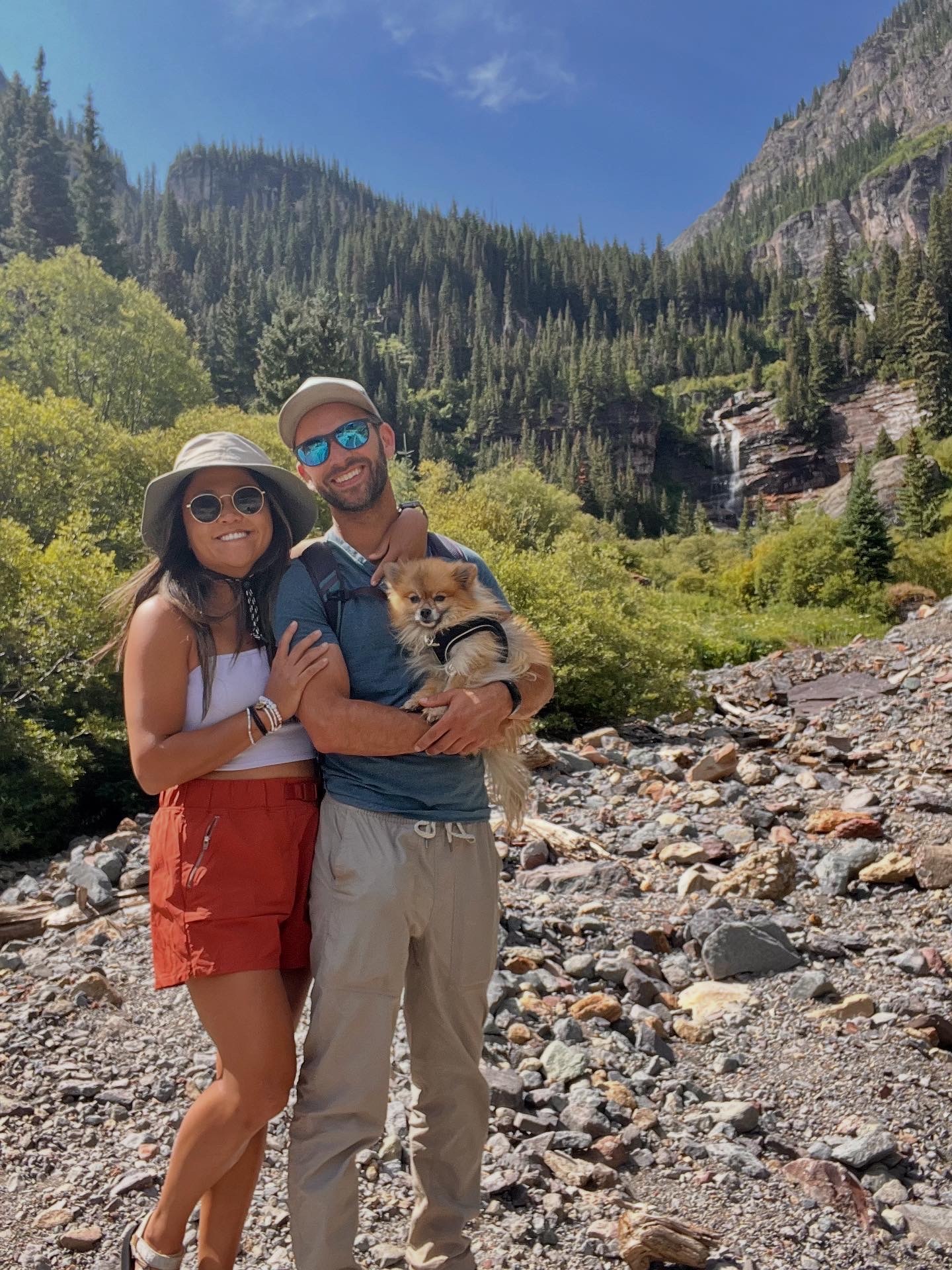 Griz with his people on a rocky trail beside a Colorado waterfall